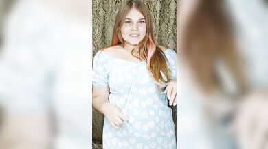 a redheaded hottie in an arousing blue dress.