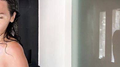 Wet T-shirt.Hot brunette takes a shower on the beach