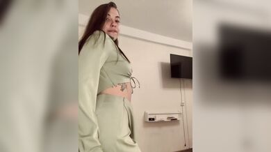 beautiful brunette in a green sexy suit.