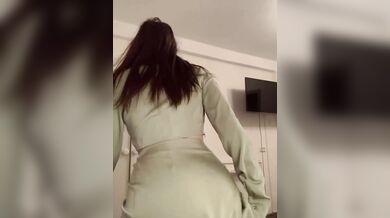 beautiful brunette in a green sexy suit.