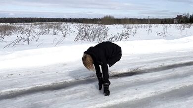 The girl is trying to walk on ice in ballet boots, but her toes are very painful