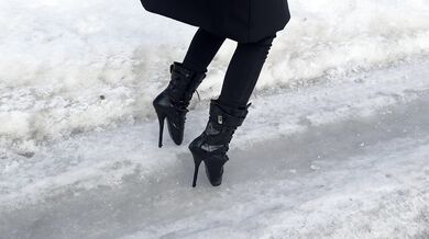 The girl is trying to walk on ice in ballet boots, but her toes are very painful