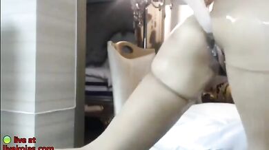 Busty Asian redhead oils her big tits